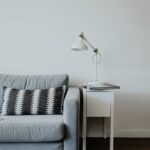 Gray sofa with solid wood side table on a walnut floor