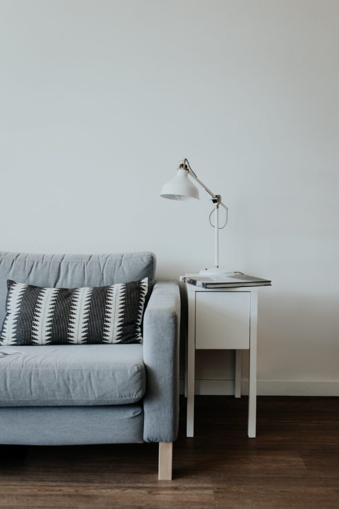 Gray sofa with solid wood side table on a walnut floor