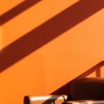 Mid-century armchair against a warm orange wall